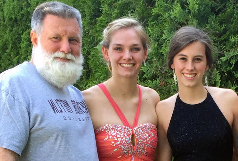 Two female Penn State Berks graduates with their father.